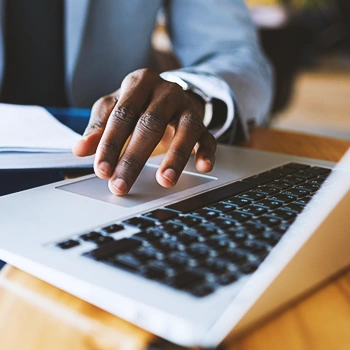 An office person using the trackpad on a laptop