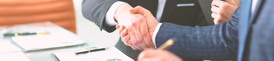 Two office workers shaking hands after dissolution of an llc in south dakota