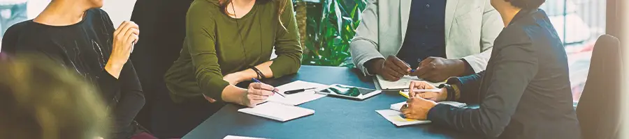 A group of employees discussing a New Mexico LLC operating agreement