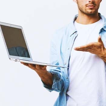 A person holding a laptop and looking up an llc in kansas