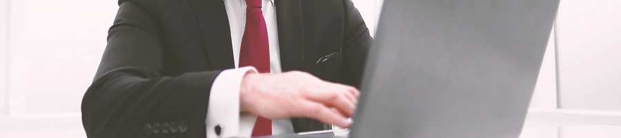 Close up shot of a businessman using a laptop