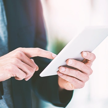 Close up shot of a man using his tablet and searching for an llc processing time in florida