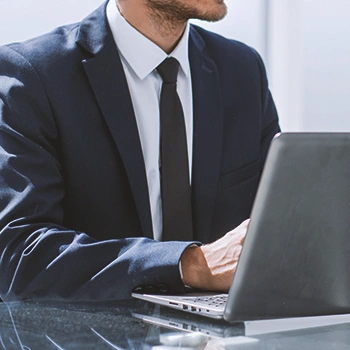 A businessman using a laptop in an office