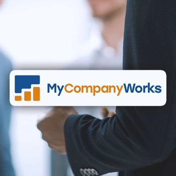 MyCompanyWorks logo in front of a businessman clenching his fist