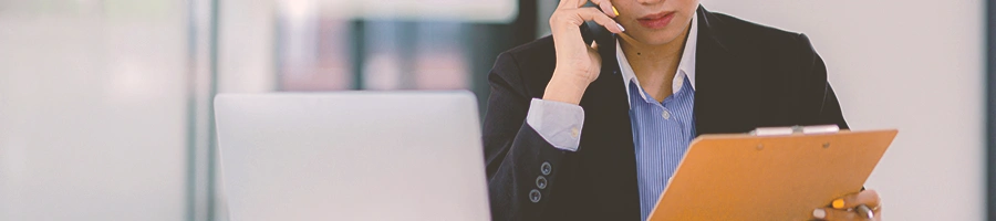 A person on the phone while holding a clipboard