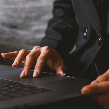 A woman looking up an LLC in New Hampshire on laptop