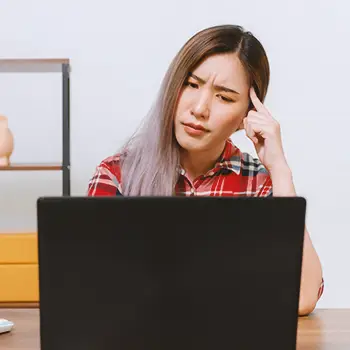 A woman looking up an LLC in New Jersey on laptop