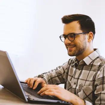 A person typing on a laptop