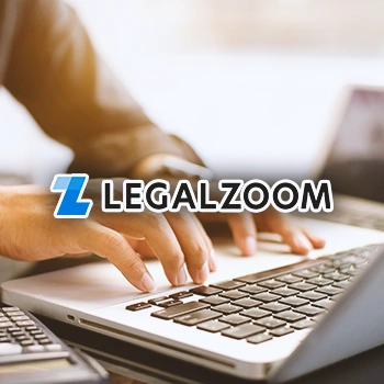 A person typing on a laptop with the Legalzoom logo