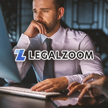 A person thinking in front of a computer with the Legalzoom logo