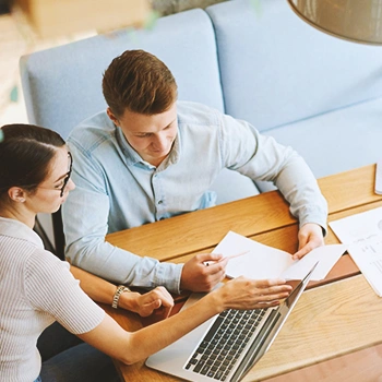 Coworkers discussing at a laptop