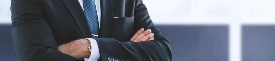 A business man posing with crossed arms