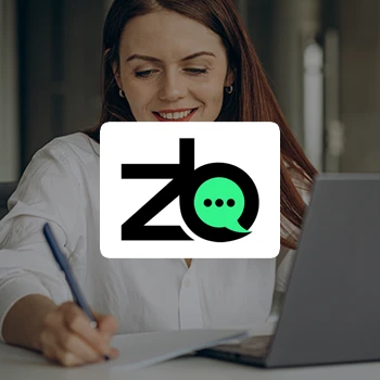 Logo of ZenBusiness with a background of a woman writing down notes in front of a laptop