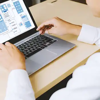 An office person using a laptop to lookup an llc in tennessee