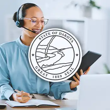 South Dakota Registered Agent logo with a business person doing work in the background