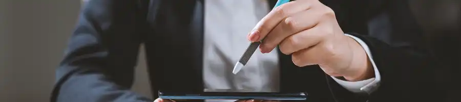 A business person holding a pen