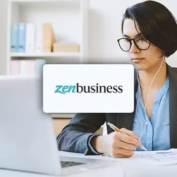 Zenbusiness logo with an office worker in front of a laptop in the background