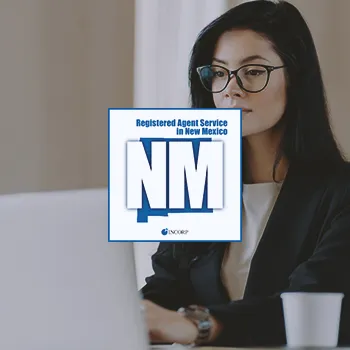 A new mexico registered agent working in an office on a laptop