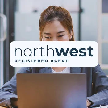 Northwest Registered Agent logo with an office worker in the background