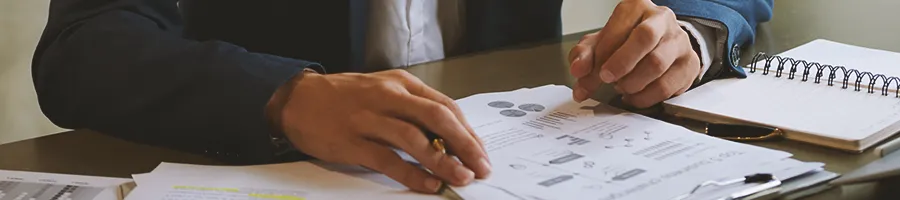 An office person analyzing paperwork