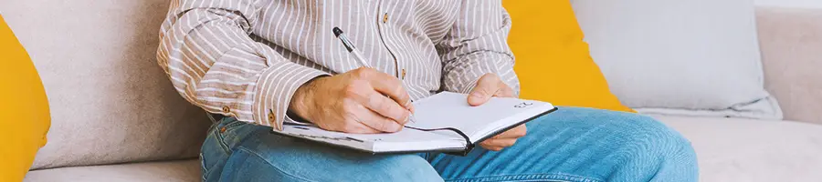 An office worker writing down the advantages of working with a registered agent service in Maryland