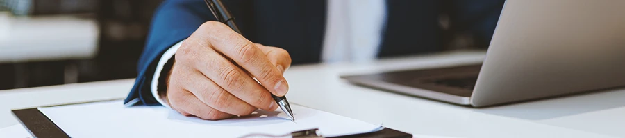 Close up shot of a business person signing something