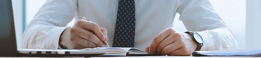 An office worker writing down on paper