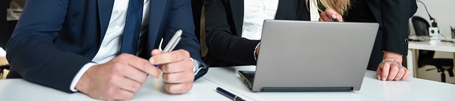 A group of employees browsing in a laptop