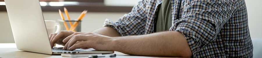 A business man looking up an LLC in Wyoming at home