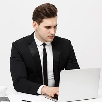 An image of a professional man searching in a laptop