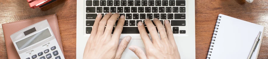 A top view image of a man browsing for Texas search options using a laptop