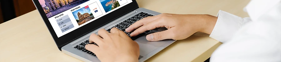 An image of a person typing in a laptop