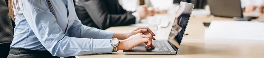 An image of woman looking up Tennessee's LLC formation process using a laptop