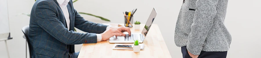 A businessman working on Vermont LLC formation process using a laptop