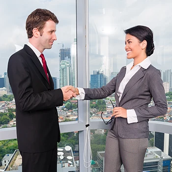 Two people shaking hands in an office