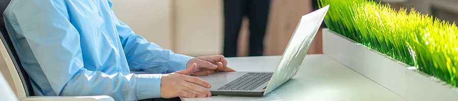 A man reading the additional features offered by MyCompanyWorks on a laptop