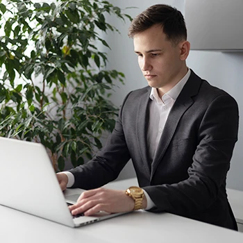 A young business man working on a laptop