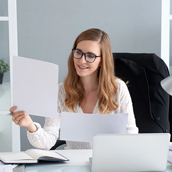 A business woman reading annual reports in her office