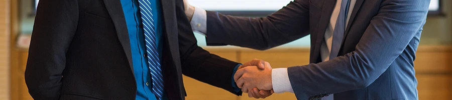 Two business men shaking hands in an office