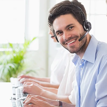 A smiling man working as a customer service agent