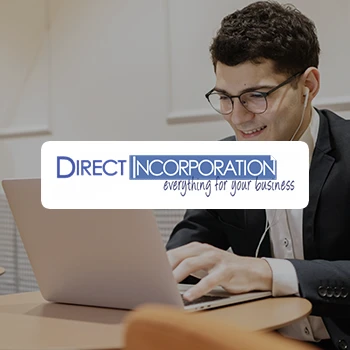 A business man using a laptop and a logo of Direct Incorporation