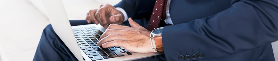 A business man searching for the downsides of 1-800Accountant using a laptop