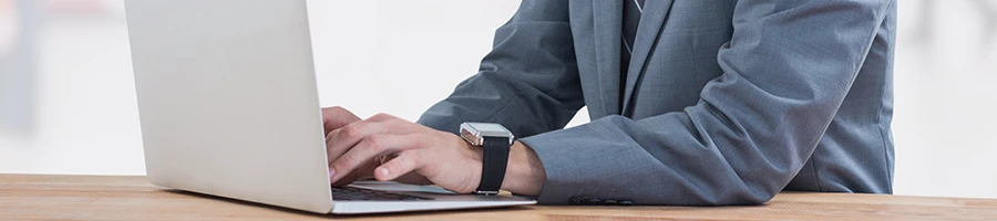 A man using a laptop on a desk