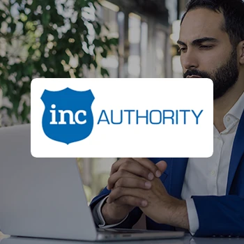 A logo of Inc Authority and a serious business man using a laptop