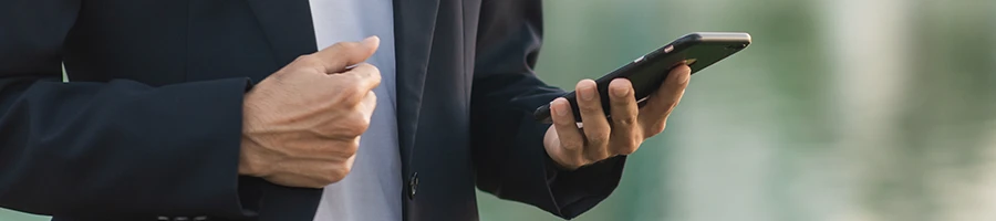 A business man reading user testimonials using his smartphone