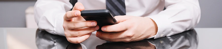 A business man reading user testimonials from a smartphone