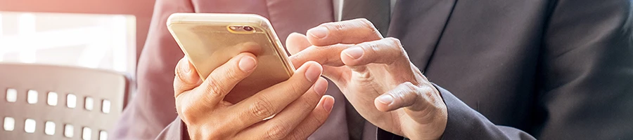 A business man using a smartphone to read user testimonials