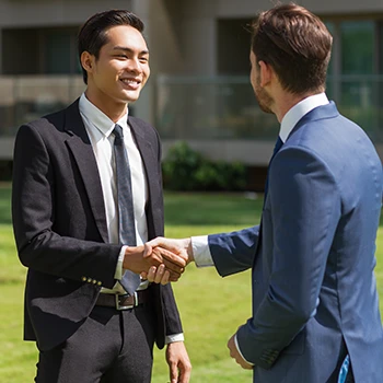 Two business men shaking hands and having a deal