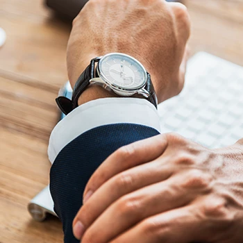 A close up shot of a man checking the time from his watch