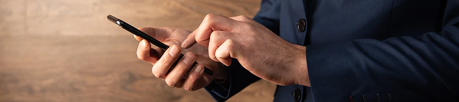 A business man writing his user testimonial using a smartphone